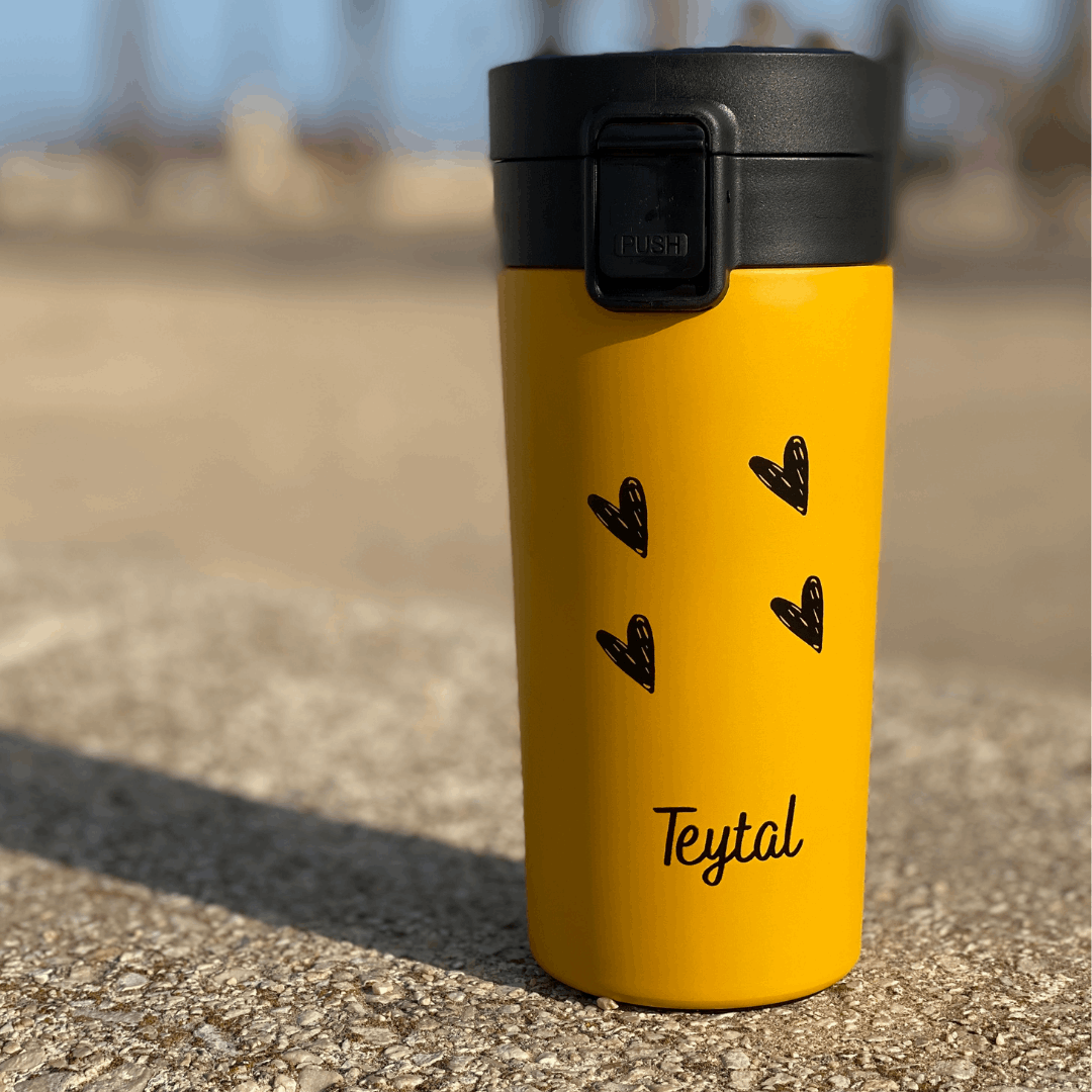 Termo amarillo mate acero inox 380 ml con tapa negra y diseño de corazones negros.
